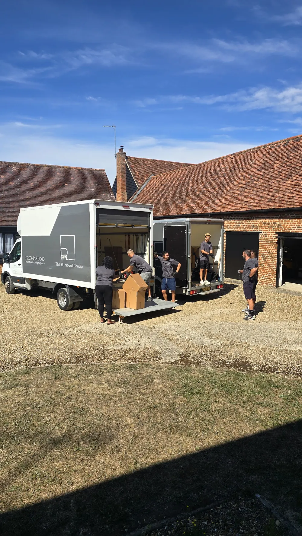 Removal crew unloading vans on a house move